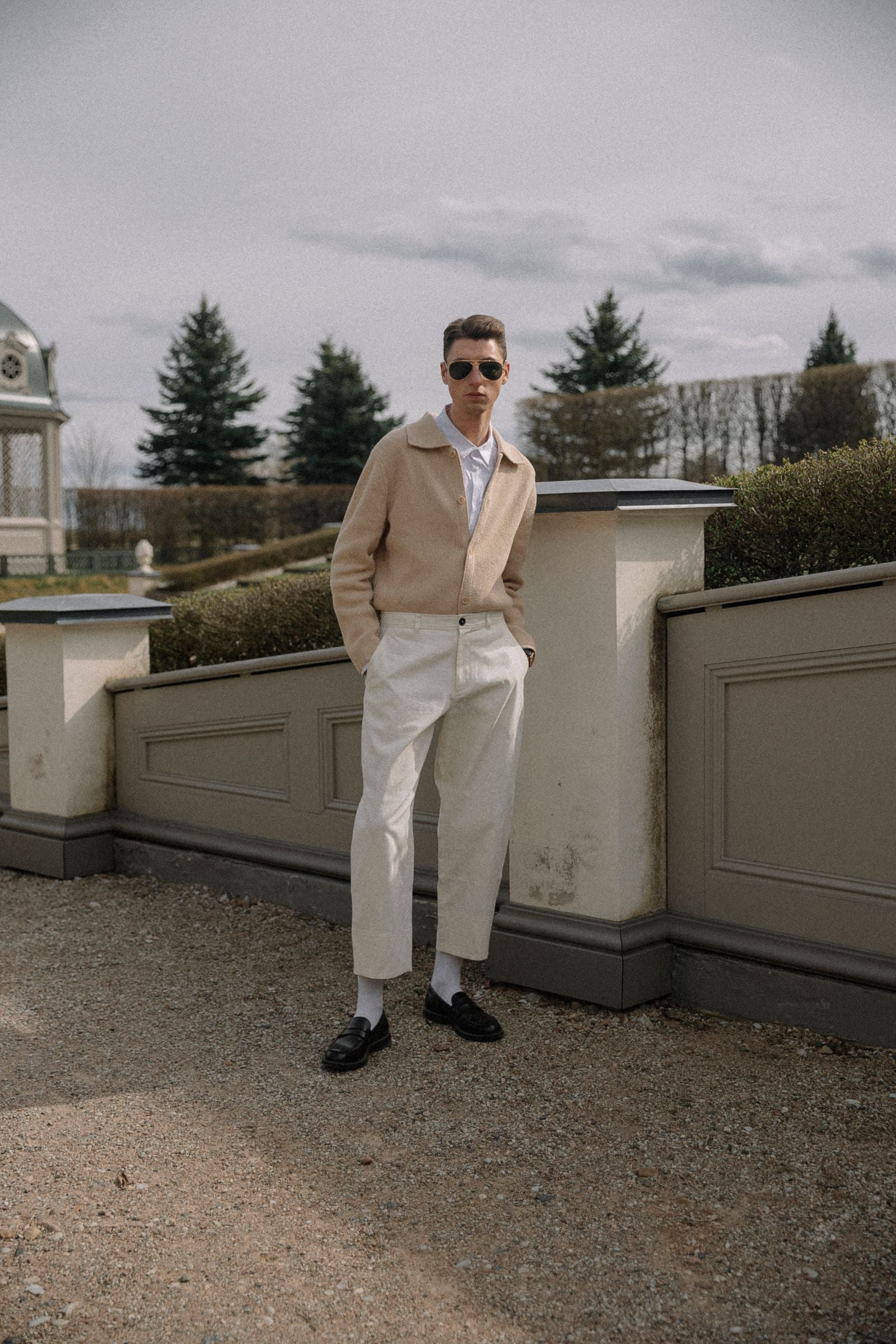 Man in a head-to-toe beige monochrome outfit posing confidently — tonal dressing to look taller and slimmer