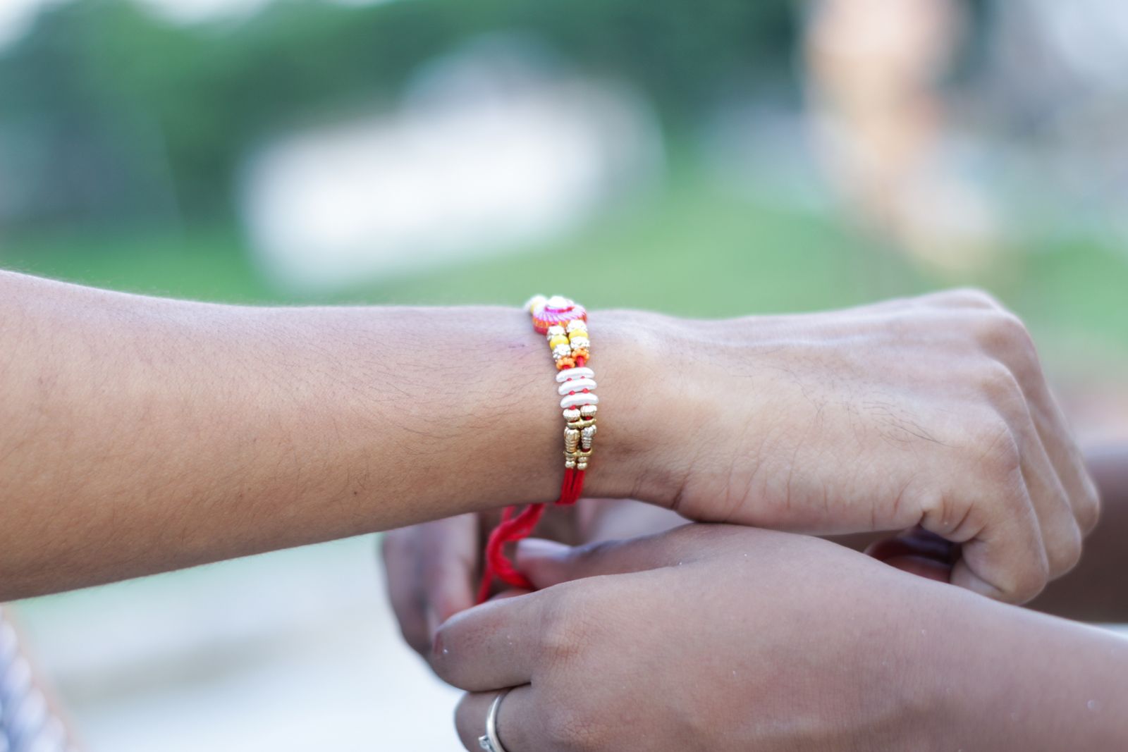 Sister tying a rakhi on her brother's wrist during Raksha Bandhan celebration in India