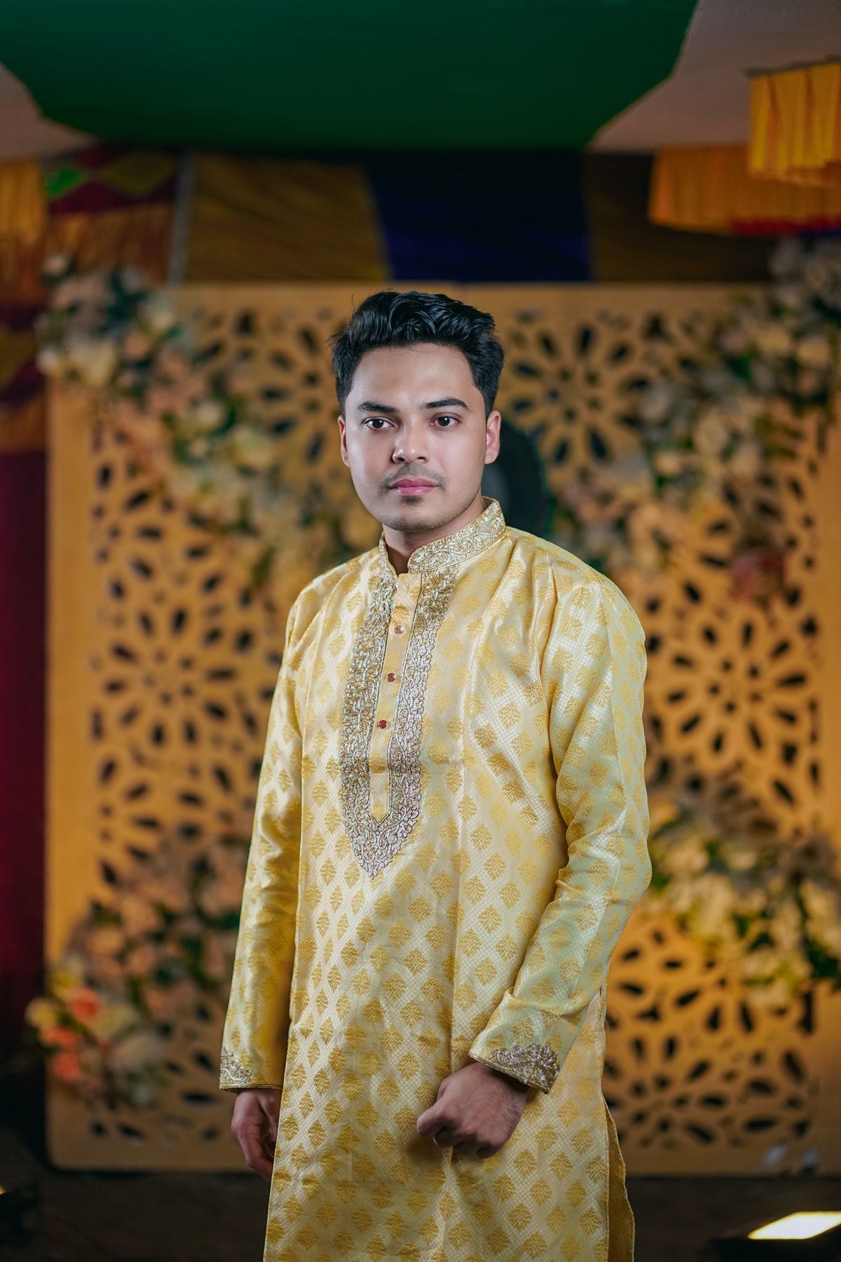 Man in saffron yellow kurta and sherwani at a festive Dussehra celebration in India