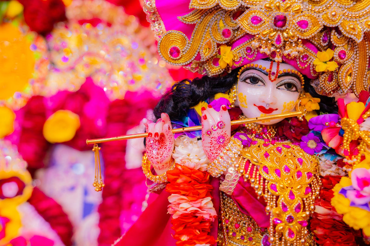 Decorated Krishna idol with flute and marigold flowers for Janmashtami 2026 puja