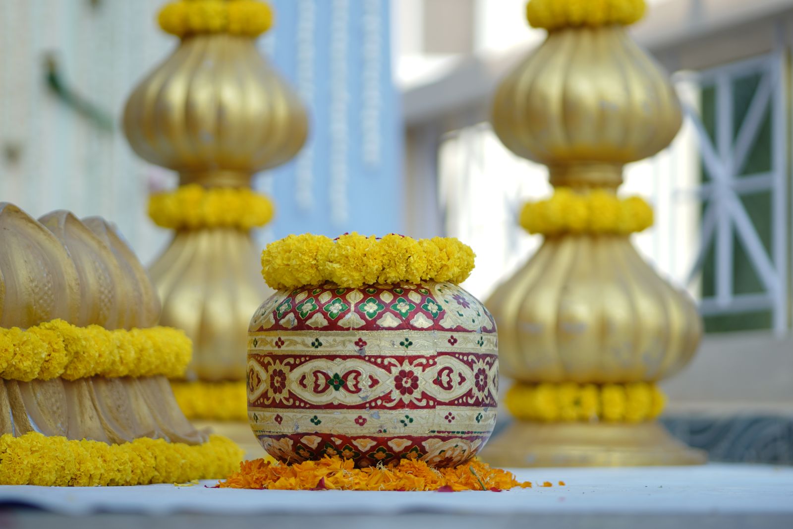 Traditional Indian haldi ceremony decorations with marigold flowers - what to wear to a haldi or mehendi