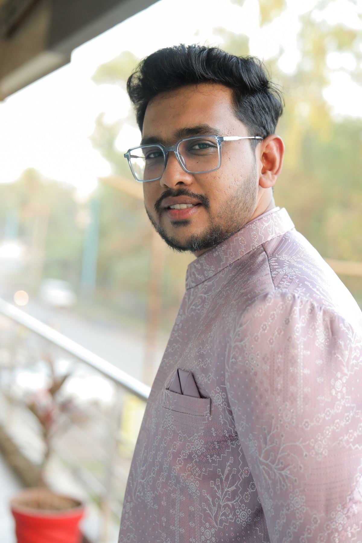 Young South Asian man in a traditional Indian kurta pyjama outdoors, blending modern and traditional style