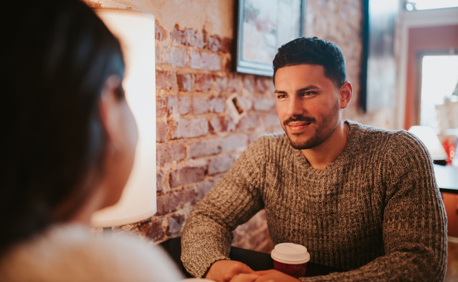 Couple on a relaxed coffee date at a cafe — first date outfit guide for Indian men