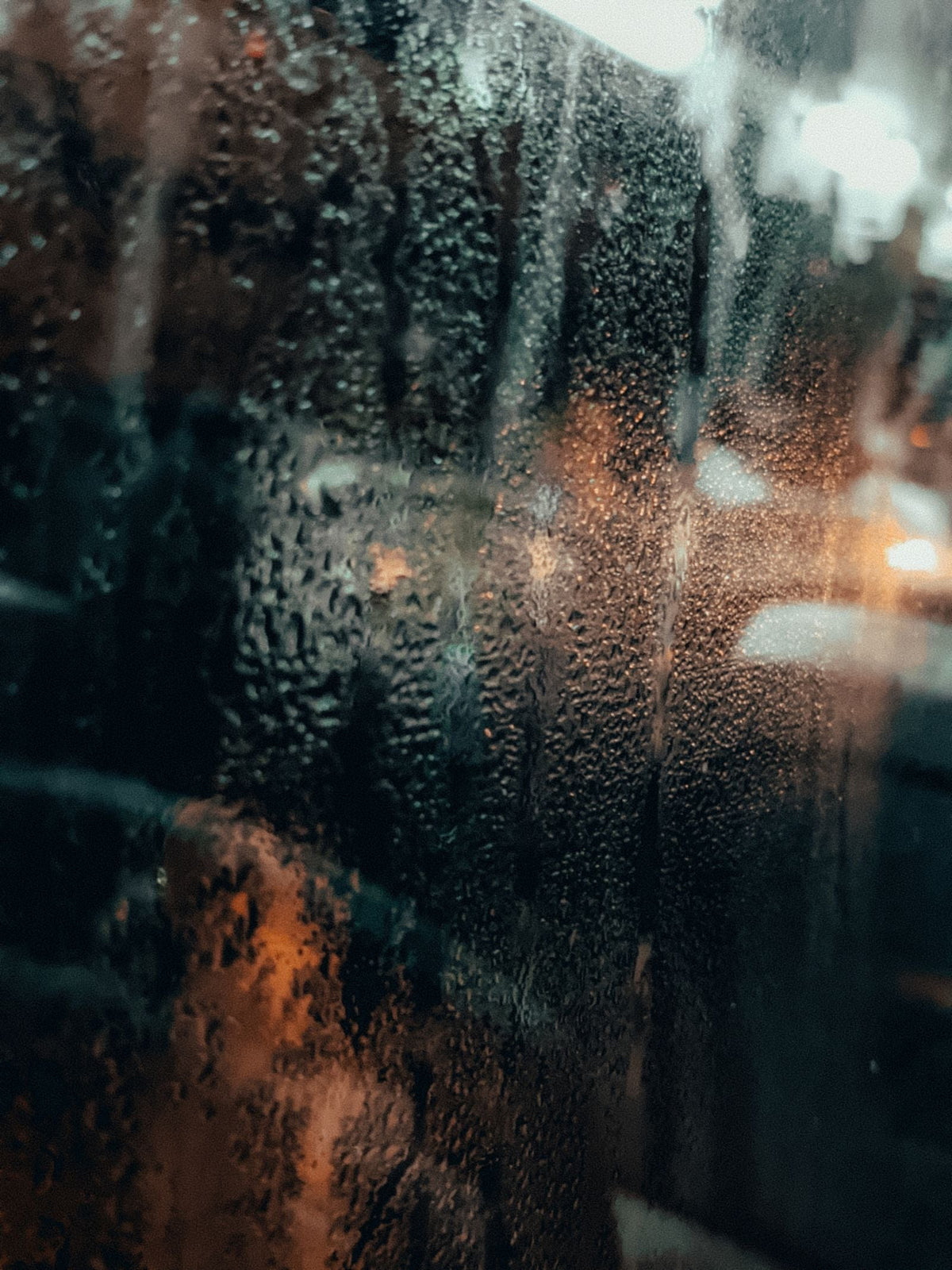 Humid monsoon rain on a window in Mumbai, India — the sticky weather linen clothing is built for