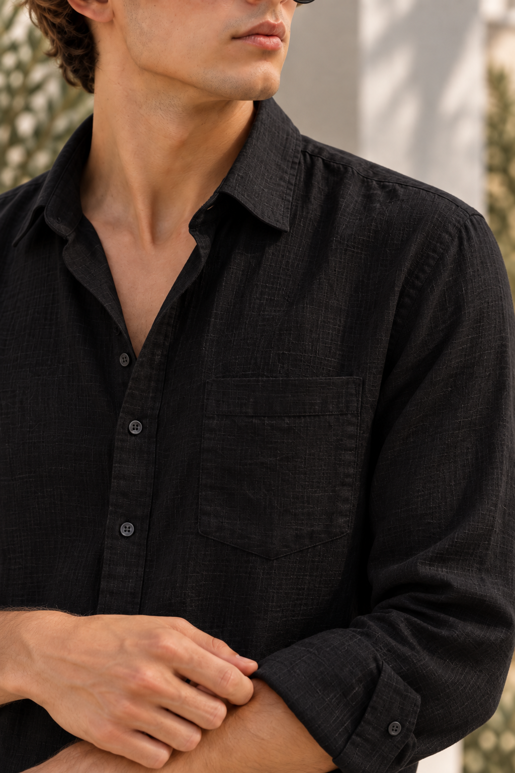 Close-up of the black linen shirt collar, button placket and chest pocket