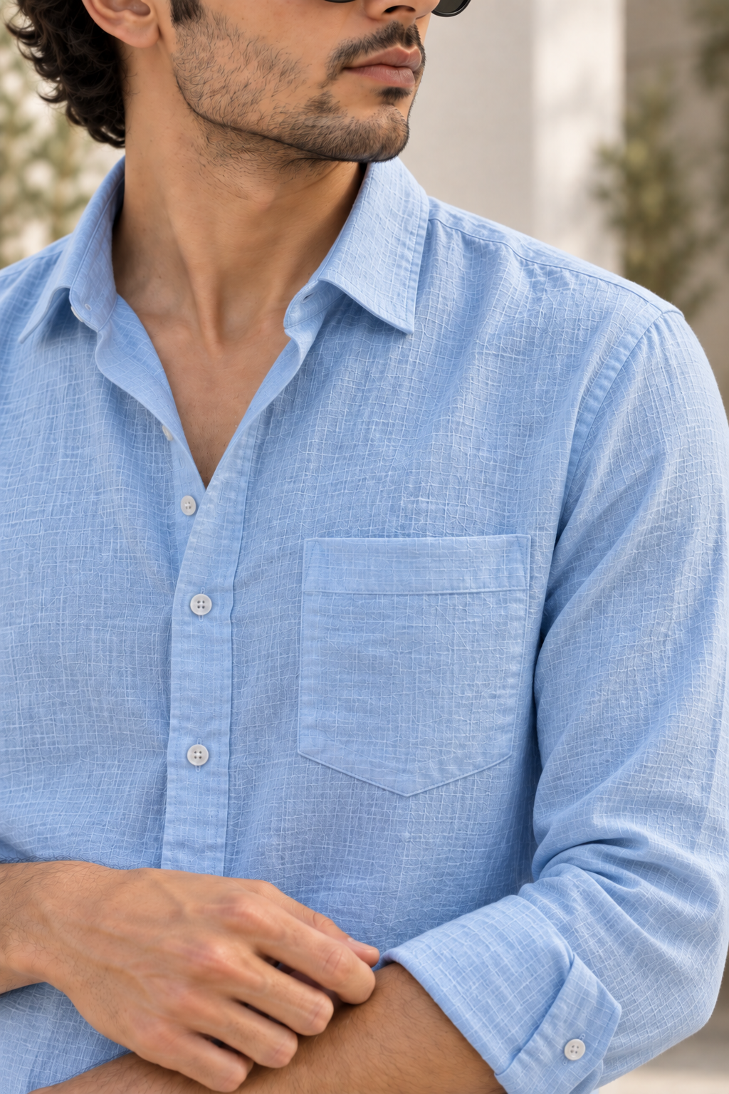 Close-up of the sky blue linen shirt collar, button placket and chest pocket