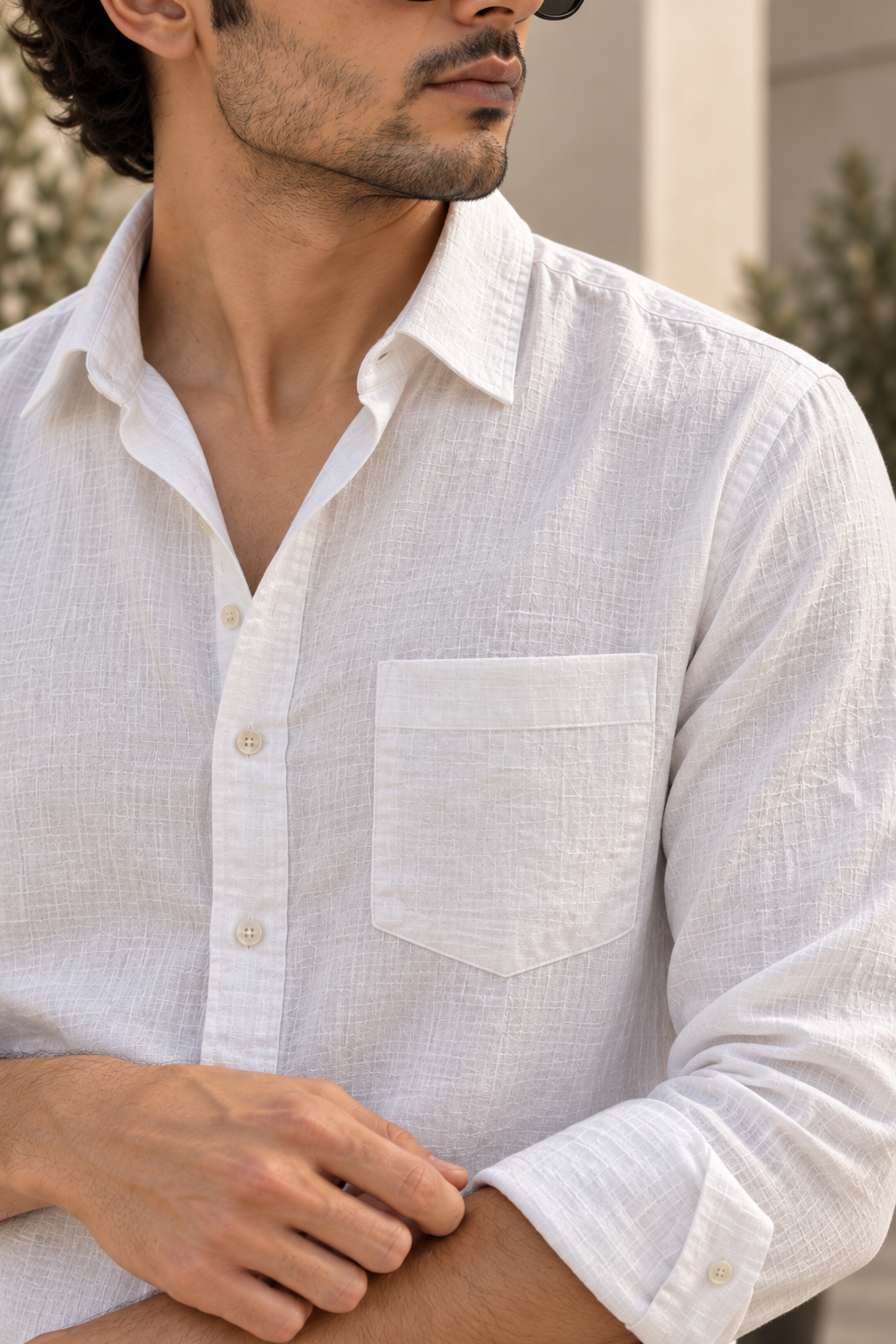 Close-up of the white linen shirt collar, button placket and chest pocket